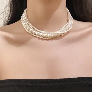 Detailed close-up showing a French style multi-layer pearl necklace choker on a woman neck