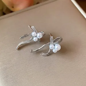 Elegant French-style bow earrings with pearls in silver-toned finish