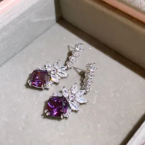 Close-up of elegant purple square stone earrings with sparkling marquise zircon accents.