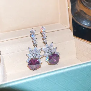 Detailed view of luxury purple gemstone drop earrings with sparkling cubic zirconia