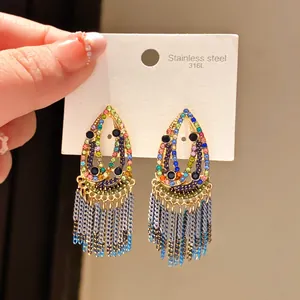 Detailed view of colorful teardrop earrings with shimmering rhinestones and tassels