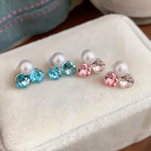Detail shot of elegant blue and pink crystal pearl clip-on earrings on velvet box
