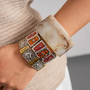 Detailed view of vintage resin bangle and hollowed heart elastic bracelets.