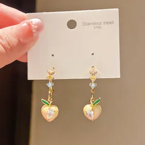 Detail view of 316L stainless steel earrings featuring heart charms and colorful zircons.