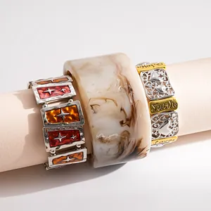 Detailed view of vintage bangles with Hope, Faith, Love engraving and marble resin