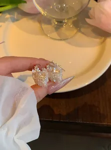 Vue détaillée des boucles d'oreilles fleurs de style français avec perles et cristaux