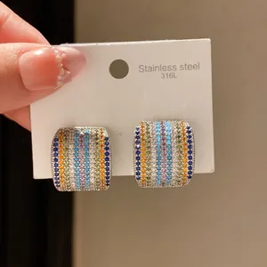 Detail of square stud earrings with colorful striped cubic zirconia on stainless steel