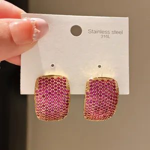 Macro detail of 316L stainless steel stud earrings pavé-set with vibrant pink zircon