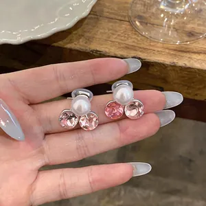 Close-up of elegant pearl and pink crystal cluster ear clips for non-pierced ears