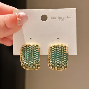Detail view of vintage green pavé zircon earrings on a 316L stainless steel card