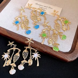Elegant gold-plated sea-themed dangling earrings featuring starfish, fish, and palm tree charms