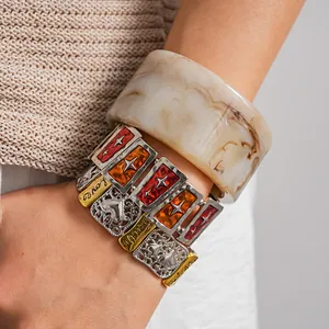 Close-up of stacked vintage stretch bracelets and marble pattern acrylic resin bangle
