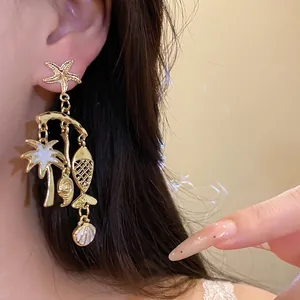 Elegant gold starfish and palm tree dangle earrings perfect for beach vacation style.