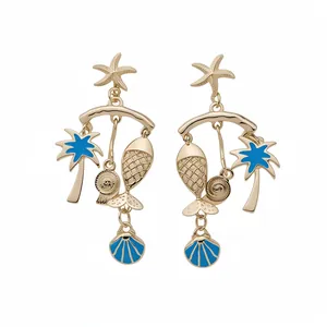 Gold starfish and palm tree dangle earrings with blue enamel ocean charms on white