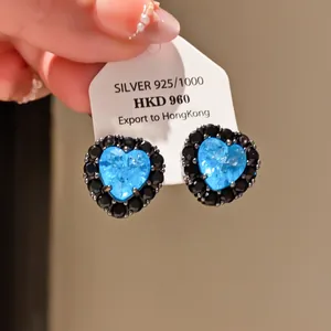 Vintage heart stud earrings with blue and black cubic zirconia on silver tag