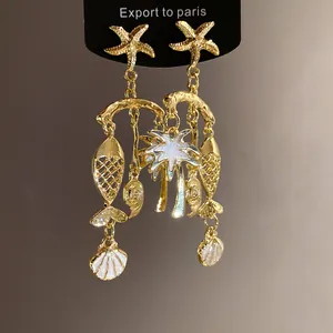 Tropical gold dangle earrings featuring starfish, seashells, and coconut tree charms