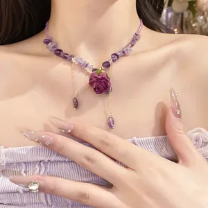 Close-up of elegant purple rose pendant necklace featuring amethyst stone beads