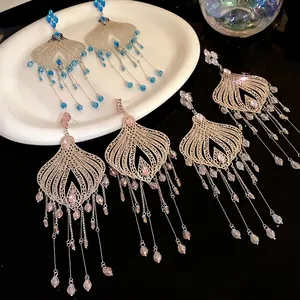 Elegant vintage ethnic tassel earrings with glass teardrop beads on silver needles.