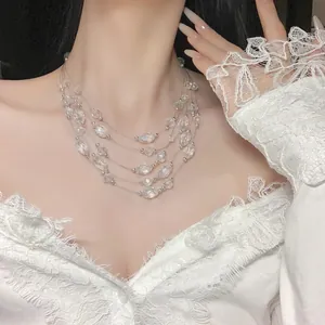 Close-up of a elegant multi-layered crystal beaded necklace on a white lace outfit