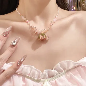 Close-up of French romantic purple crystal necklace with dried rose pendant on model