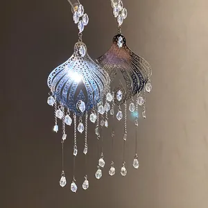 Detailed view of vintage silver tassel earrings featuring sparkling glass droplets.
