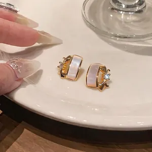 Elegant C-shaped mother of pearl iris stud earrings with sparkling zircon accents