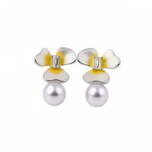 Floral silver stud earrings with yellow accents, center crystal, and white pearl drop