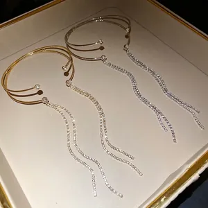 Elegante bracciale rigido aperto a doppio strato con nappe di strass in oro e argento.
