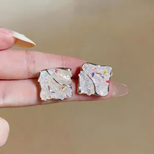 Close-up of elegant iridescent square stud earrings featuring a unique crushed ice effect