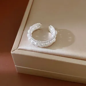 Elegant multi-layer pearl ring with zircon accents and geometric round design in silver