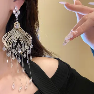 Detailed close-up of silver ethnic tassel earrings featuring clear glass water drops