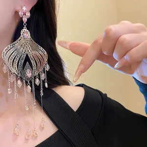 Detailed close-up of ethnic style silver teardrop fringe earrings with elegant pink crystals