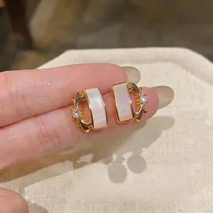 Elegant iris flower gold earrings featuring iridescent mother-of-pearl and zircon accents.