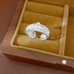 Close-up of elegant multi-layer silver ring with white pearls and zirconia accent