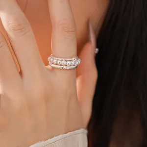Detailed view of elegant multi-layer silver ring set with pearls and zircon stones