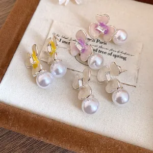 Elegant oil-drip flower stud earrings with white pearl drops and sparkling crystal center