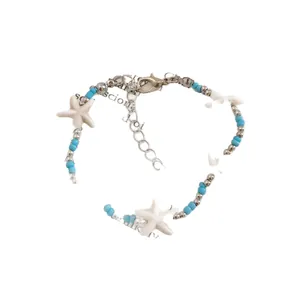 Ocean themed blue beaded bracelet featuring white starfish charms for summer beach vacations