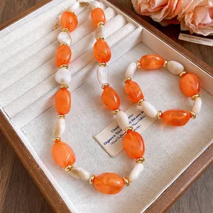 Elegant vintage orange and white acrylic oval bead necklace and bracelet jewelry set