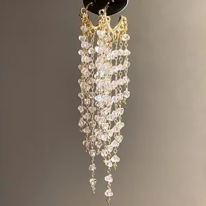 Fashionable gold hoop earrings with long cascading clear crystal tassels for women
