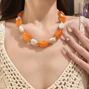 Close-up of vintage elegant orange and white acrylic oval beaded collarbone necklace