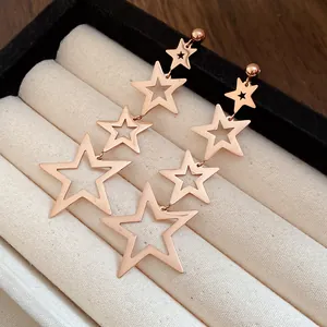Close-up of rose gold stainless steel star tassel earrings in a jewelry box