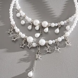 Detailed view of elegant pearl necklace with crystal star charms and waterdrop tassels