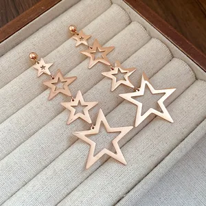 Elegant rose gold stainless steel star tassel earrings displayed in a jewelry box