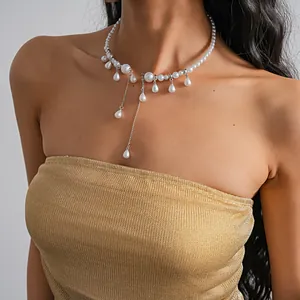 Elegant pearl choker necklace with dangling teardrop pendants on a model