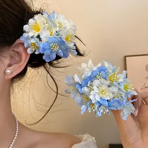 Elegant blue and white fabric flower hair clips set shown on model for a romantic vacation look