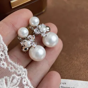 Detailed view of French luxury fireworks ear clips with elegant pearls and zircons