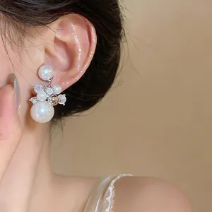 Detail view of French luxury pearl and zircon ear clip with elegant firework cluster design