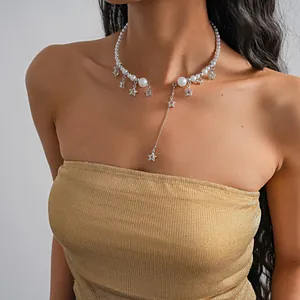 Close-up of pearl choker necklace with silver star charms and a long tassel drop