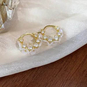 Vue détaillée des boucles d'oreilles fleurs plaquées or 14 carats avec zircones brillants