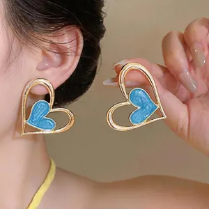 Pendientes de botón de corazón minimalistas en oro y aceite azul, estilo dulce